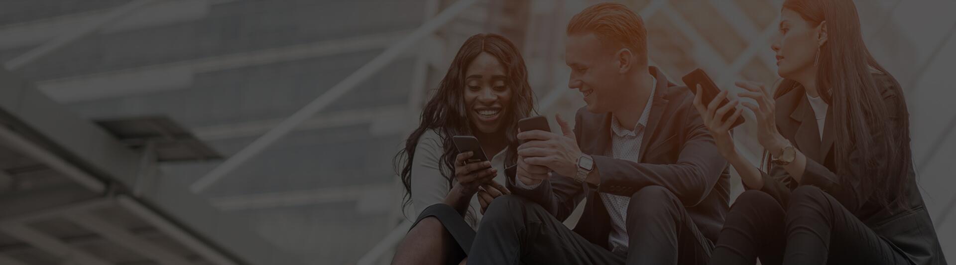 group of device users enjoying using their devices on outside building stairs