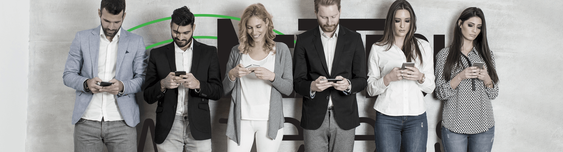 adult line up against logo wall with participants all looking at their mobile devices